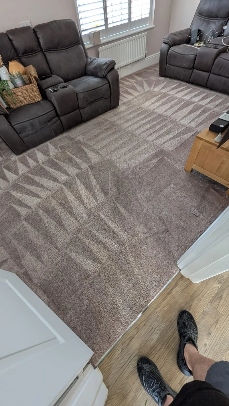 Cleaned living room carpet between reclining sofas