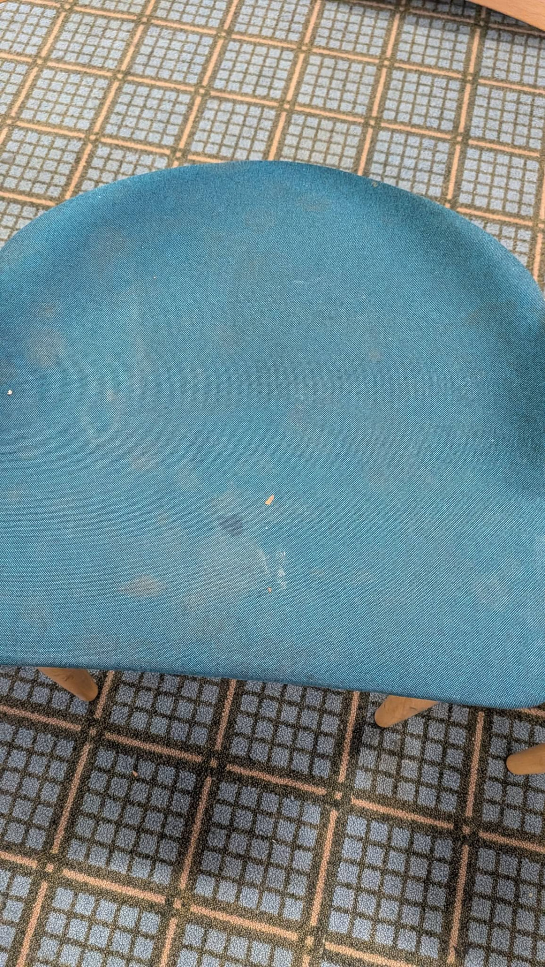 Blue upholstered wooden chair with visible marks before cleaning
